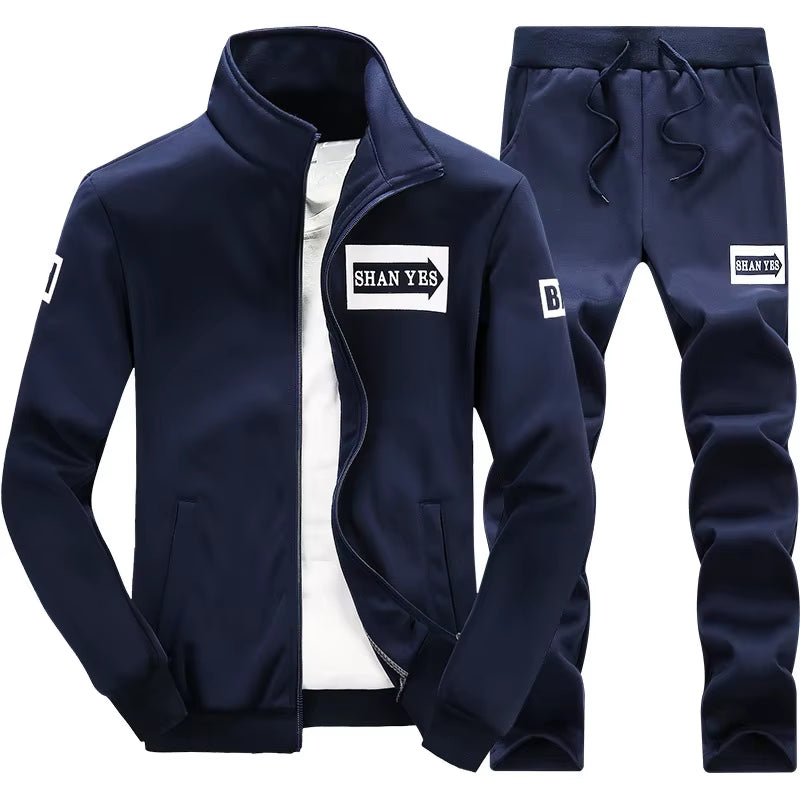Conjunto deportivo de otoño para hombre. Sudadera y pantalón a juego, con diseño patchwork, cuello alto y capucha.