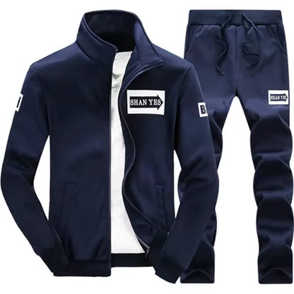 Conjunto deportivo de otoño para hombre. Sudadera y pantalón a juego, con diseño patchwork, cuello alto y capucha.