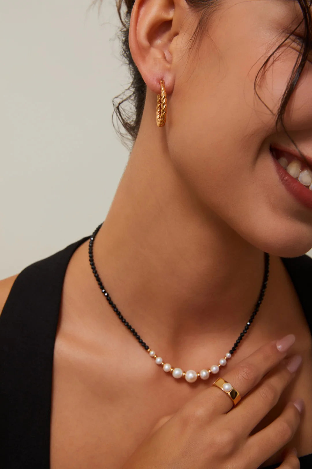 Collar con cuentas doradas y perla de espinela negra.